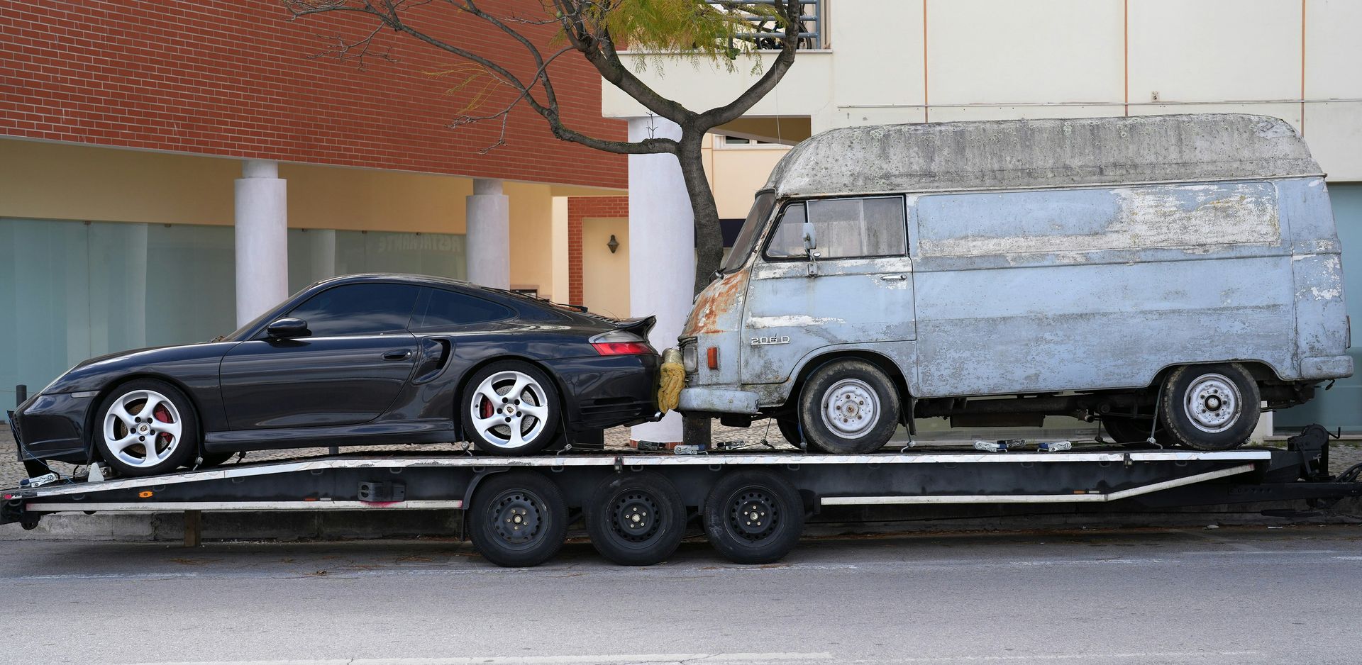 A car being towed on a flatbed tow truck